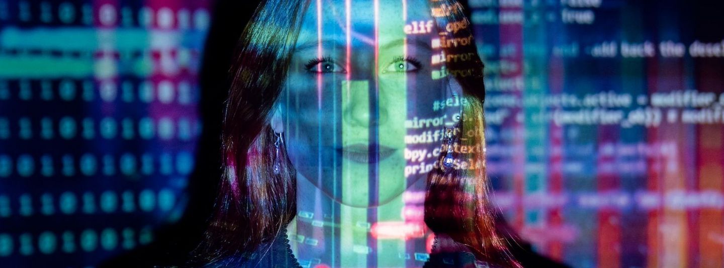Woman standing in front of a wall onto which code is projected