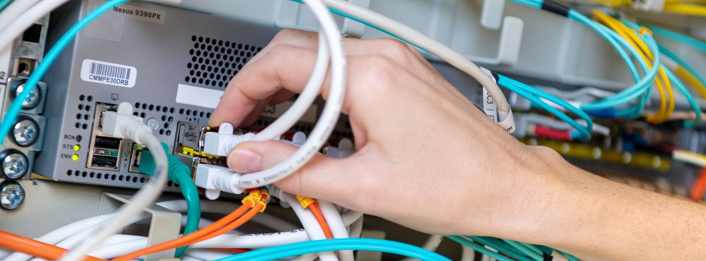 Hand puts cable in server